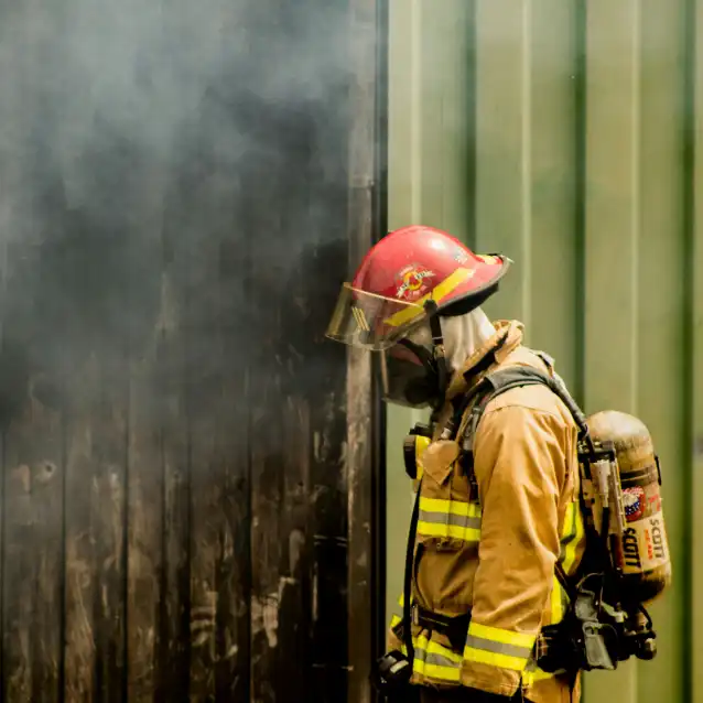 Firefighter next to building