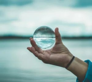 Hand holding a glass sphere